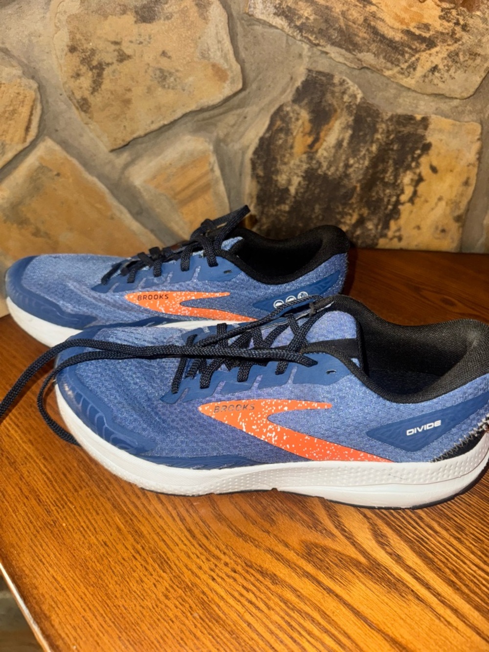 Brooks blue running shoes with orange logo accents